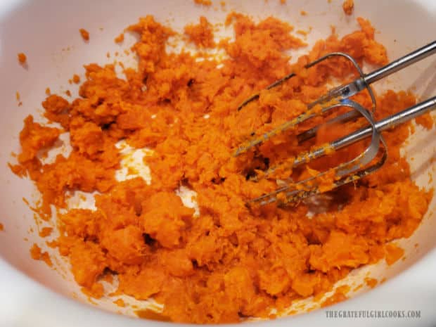 The sweet potatoes are mashed to remove chunks before adding other ingredients.