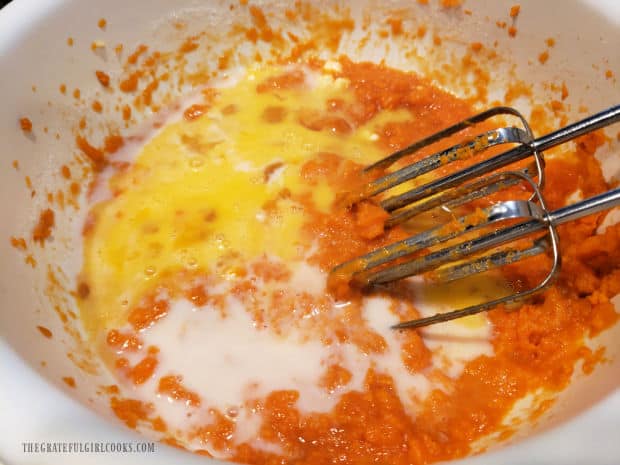 Sugar, eggs, milk, vanilla, butter, cinnamon and salt are mixed with the mashed sweet potatoes.