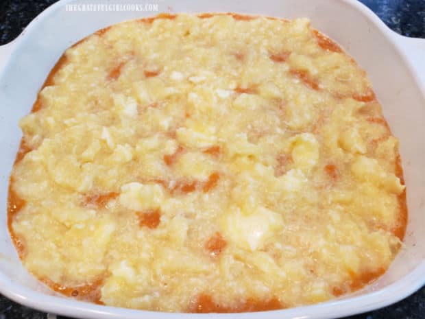 A layer of pineapple topping is added to the top of the sweet potato mixture in casserole dish.