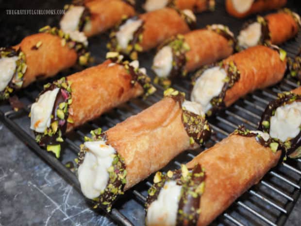 Cold citrus ricotta filling is piped into the decorated cannoli shells before serving.