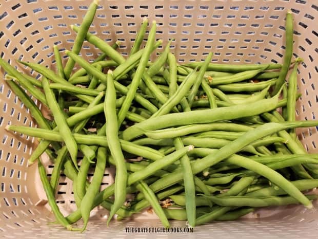 Fresh green beans ready to have their ends trimmed for this dish.