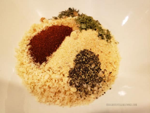 Panko bread crumbs and a variety of spices are combined in a bowl.
