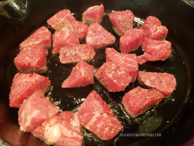 Steak bites are seared in hot oil in a very hot skillet until browned and crispy.