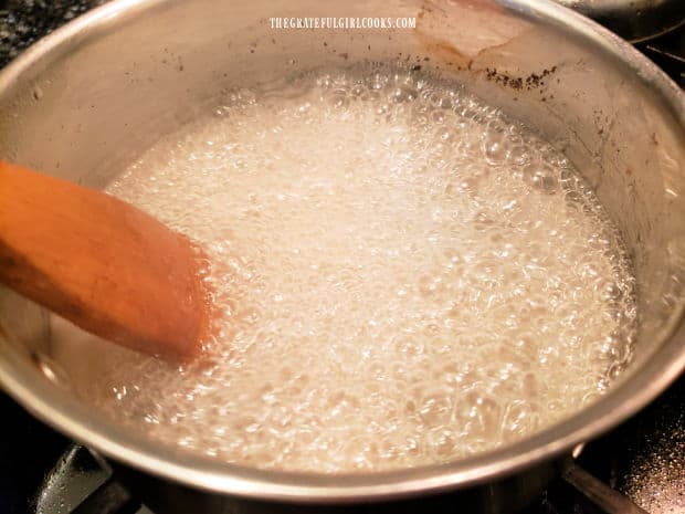 After coming to a boil, lemon sauce is cooked for 2 more minutes, stirring as it cooks.