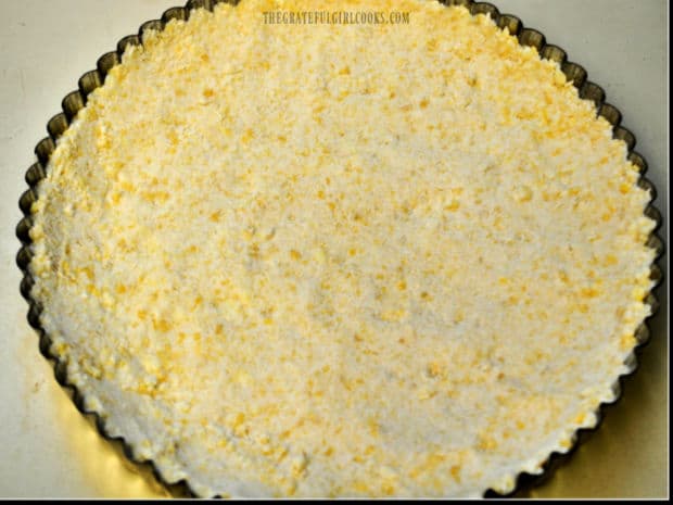 Shortbread mixture is firmly compacted in tart pan to form a crust.
