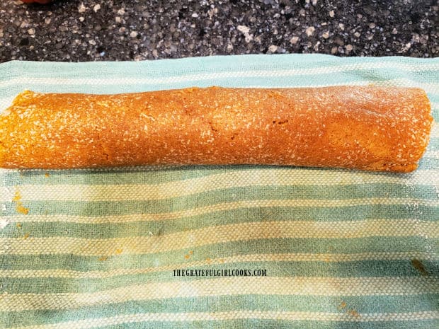 The pumpkin cream cheese roll will now be well-wrapped and refrigerated or frozen before serving.