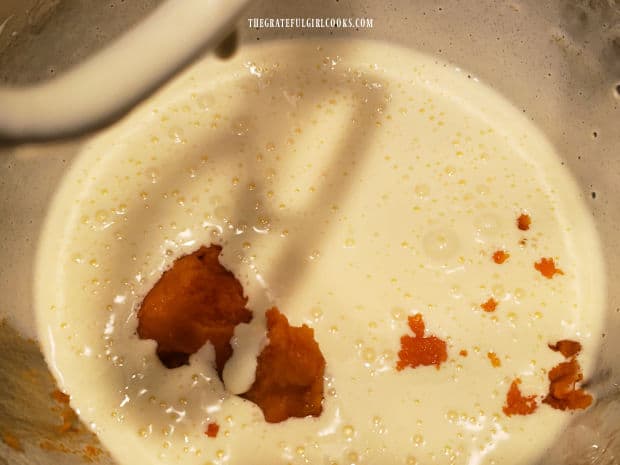 Pumpkin puree and lemon juice are mixed into the egg mixture for the pumpkin roll batter.