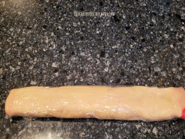 After being rolled, the cookie dough is sealed in plastic wrap and refrigerated until firm.
