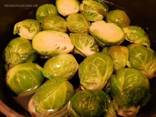 Halved brussel sprouts are boiled in water for 7 minutes, or until tender.