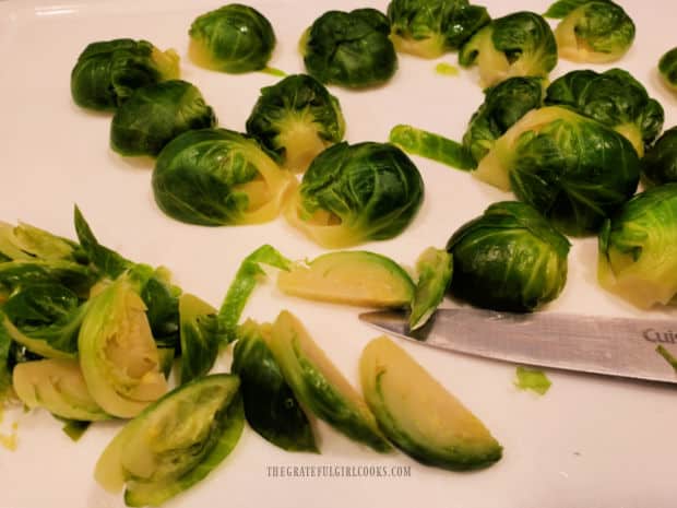 Tender-cooked brussel sprouts are cut into thin slices for the casserole.