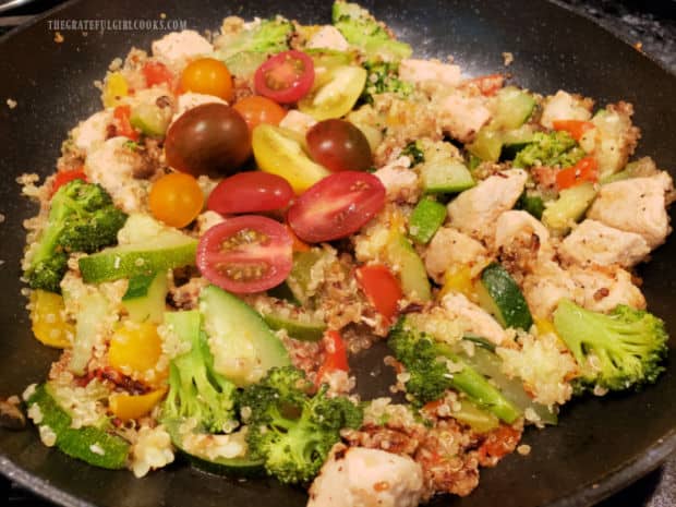 Halved cherry tomatoes are added to te Chicken, Quinoa and Veggies before serving.