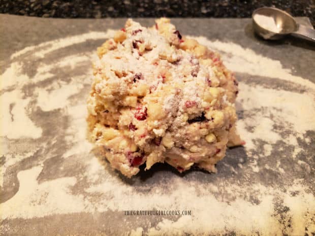 Scone dough is shaped in a ball, and placed on floured surface for rolling.