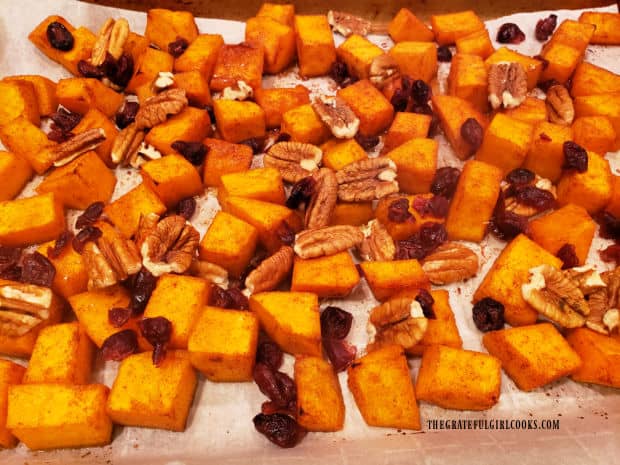 Dried cranberries and pecan halves are stirred into butternut squash halfway through baking time.