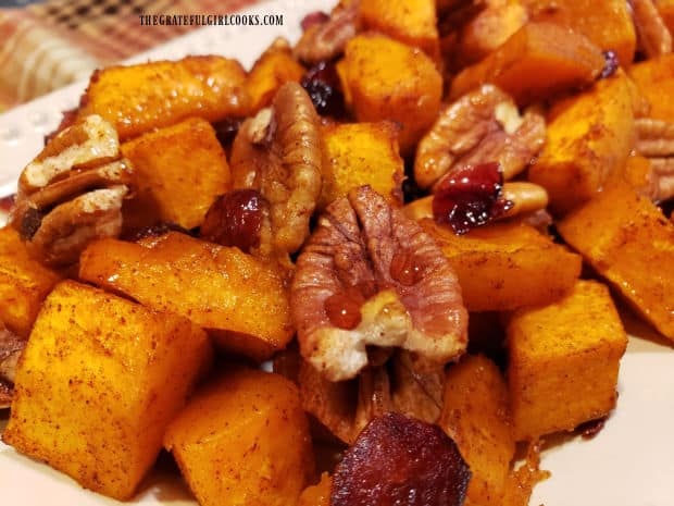 Roasted maple butternut squash is drizzled with additional maple syrup before serving.