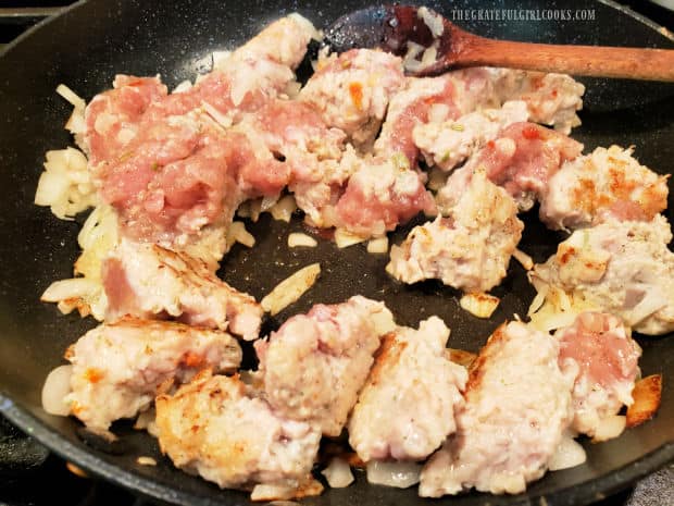 Chicken Italian sausage is portioned in large chunks and browned in oil with onions.