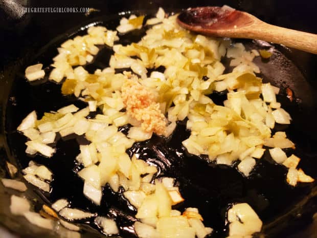 Minced garlic is added to the onions and jalapeños in skillet.