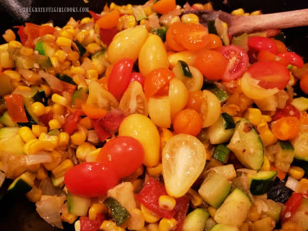 Halved cherry tomatoes (red and yellow) are added to the Southwest Veggie Skillet.