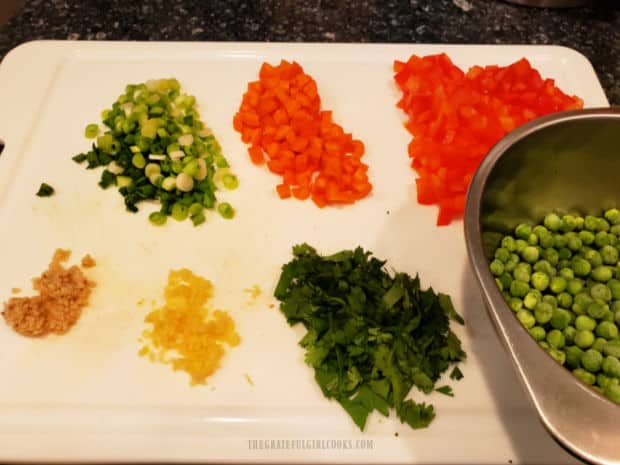 Scallions, carrots, red bell peppers, garlic, ginger, cilantro and peas are prepped and ready!