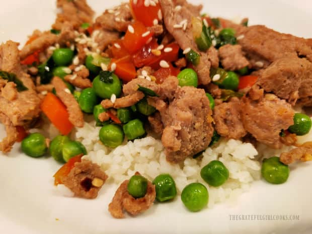 A serving of the turkey veggie stir fry, placed on top of white rice.