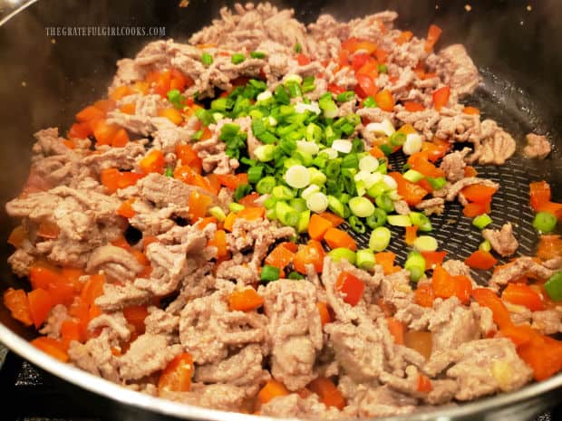 Chopped scallions (green onions) are stirred into the turkey veggie stir fry.