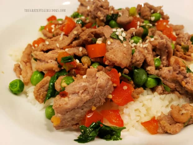 The turkey veggie stir fry is served hot, on a bed of white rice.