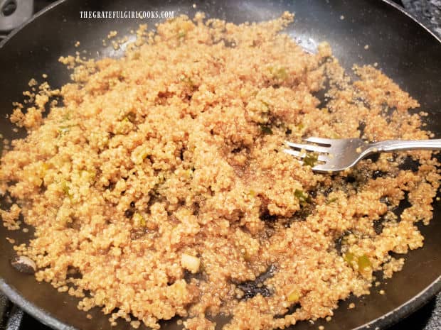 Asian-inspired couscous is fluffed with a fork before serving, once liquid has been absorbed.