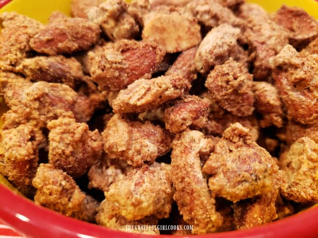 Close up photo of the cinnamon glazed almonds in a bowl.