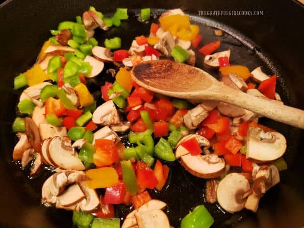 Baby Bella mushroom, and red, green and yellow bell peppers are stir-fried.