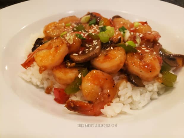 A serving of Teriyaki Shrimp Bowl, served on a bed of rice in a white bowl.