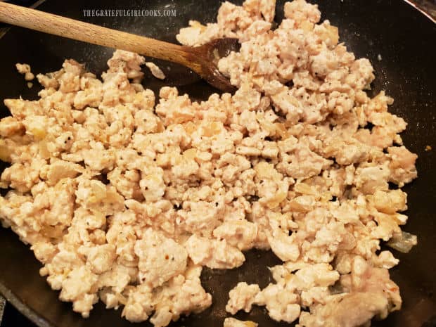 Seasoned with salt/pepper, the ground chicken continues cooking until fully cooked through.