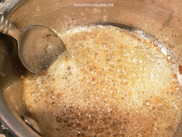 Browned butter cooking in a saucepan, with minced garlic added for flavor.
