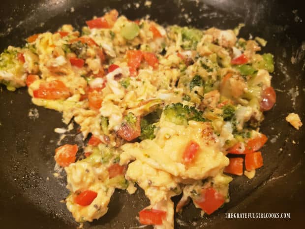 Egg, bacon and veggie scramble, fully cooked in the skillet.