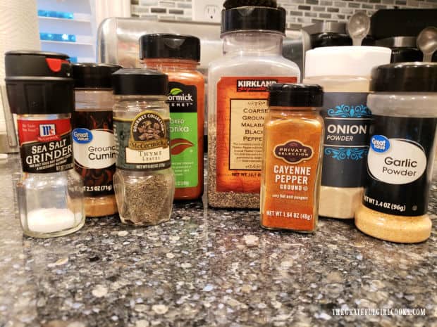 Bottles of dried spices used to flavor the ground beef burger patties.
