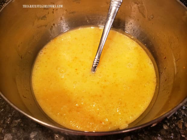 Eggs, oil, buttermilk and orange zest are whisked together in a medium-sized bowl.