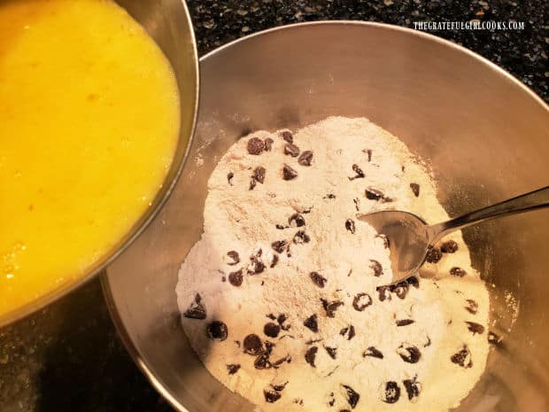 The wet ingredients are poured into the bowl of the dry ingredients to form a batter.