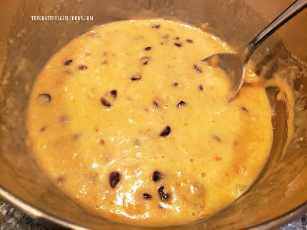 After being stirred, the batter for chocolate chip orange bread is ready for the loaf pans.