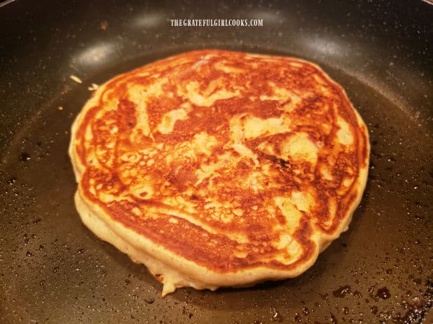 Once the bottom browns, pancake is flipped to cook the other side.
