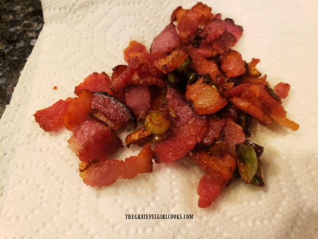 Pan-cooked bacon and green onions drain on paper towels.