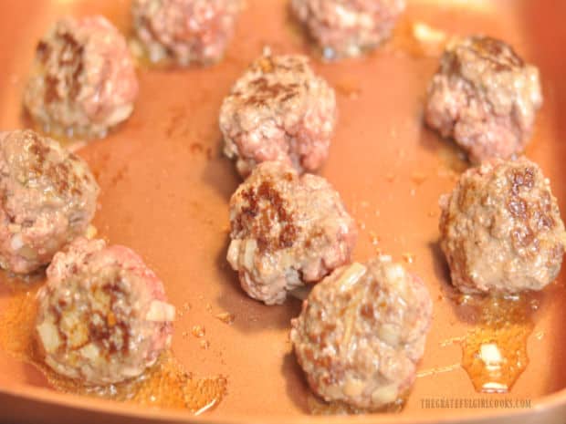 Meatballs are turned and continue cooking, browning all sides and cooking through.