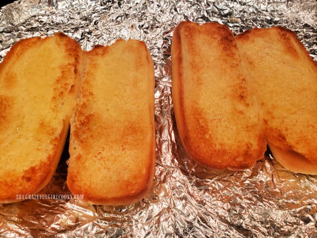 After broiling, the garlic butter hoagie rolls are lightly browned and toasted.