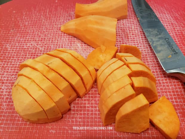 Sweet potatoes are peeled, sliced, then cut into quarters before seasoning.