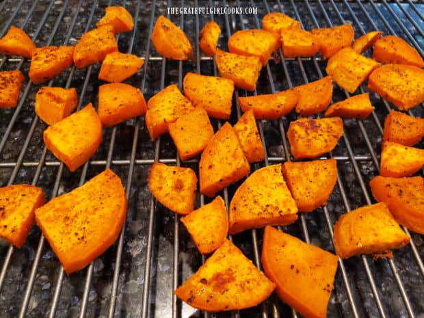 Seasoned, roasted sweet potatoes cool on a wire rack.