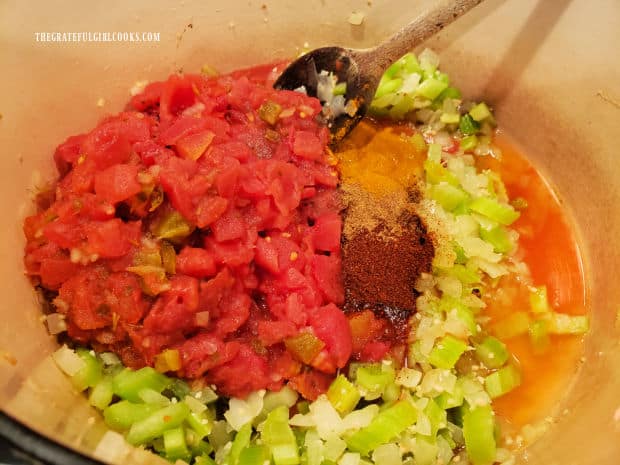 Fire-roasted tomatoes, spices and hot sauce are added to the pan.