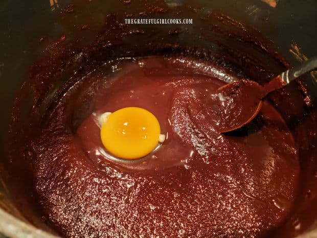 Eggs are stirred, on at a time, into cooled batter, and stirred to combine.