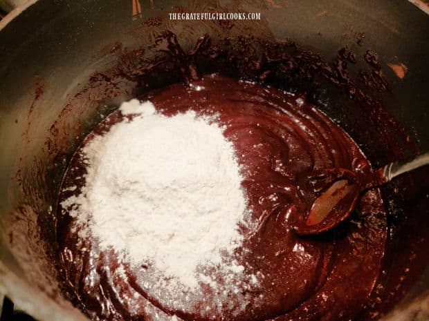 Flour is added and then stirred into the batter for the mocha cinnamon brownies.