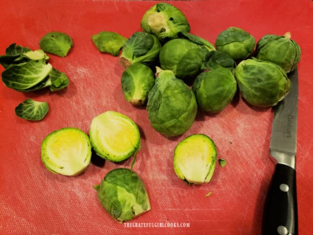 Brussel sprouts are sliced lengthwise before seasoning.