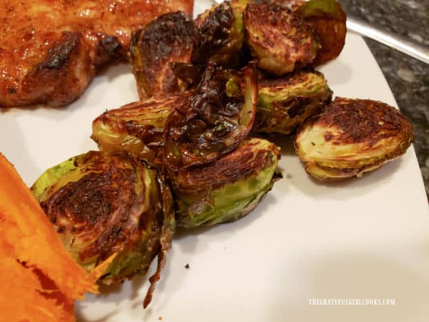 Roasted Brussel Sprouts For Two, served with a sweet potato and pork chop.
