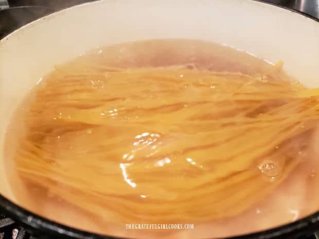 Linguini is cooked in boiling, salted water in a large pot.