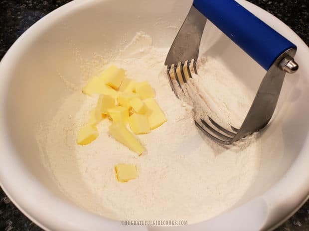 Cold butter is cut into the dry scone ingredients using a pastry blender.