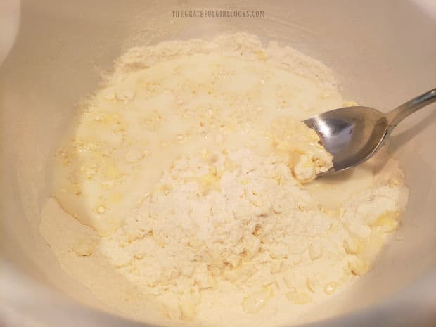 Buttermilk is stirred into the bowl of scone batter until just combined.